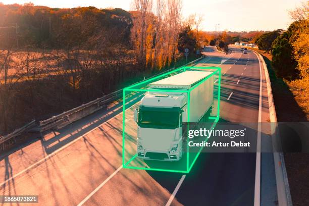 sustainable transport with a semi truck on the highway with autonomous smart technology. - autonome technologie stock-fotos und bilder