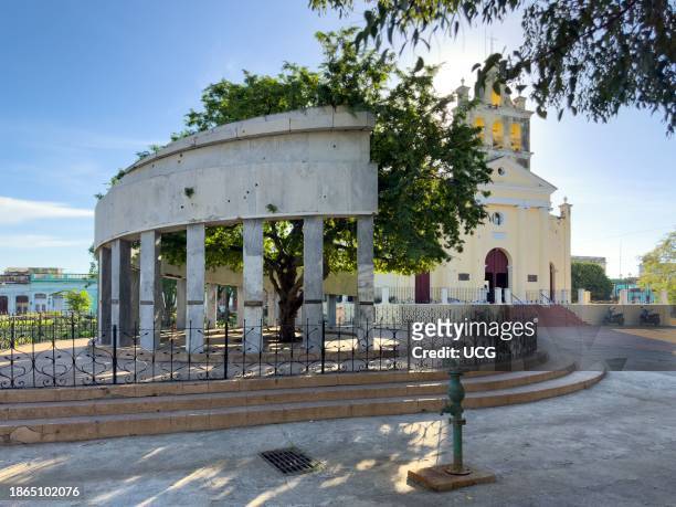 Santa Clara, Cuba, El Carmen park or square. The colonnade marble monument marks the foundation place of the city. The colonial Catholic church of El...