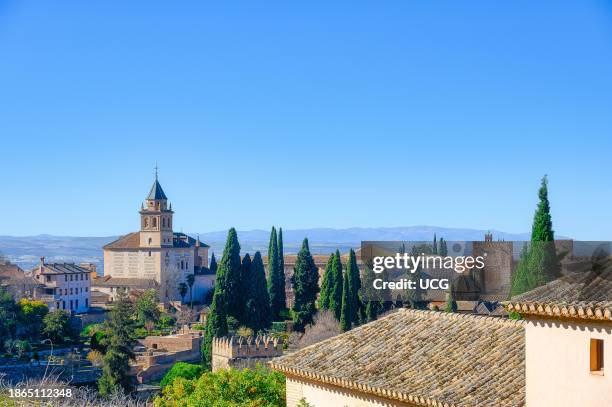 Granada, Spain, an ancient church amid a Spanish landscape. Point of view from the Alhambra fortress and palace complex.