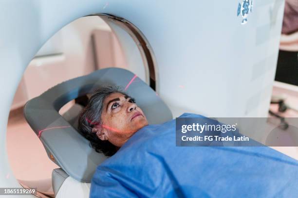 senior woman on a tomography exam at hospital - ct scan stock pictures, royalty-free photos & images