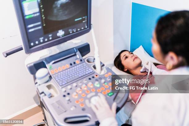 mid adult woman on ultrasound exam at hospital - throat exam stockfoto's en -beelden