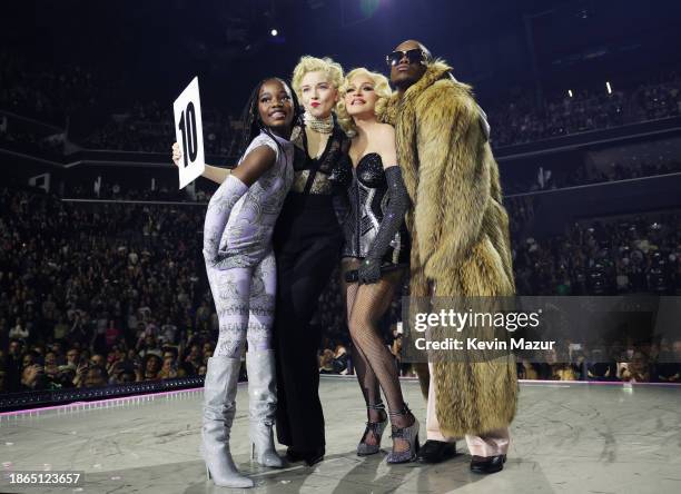 Estere, Julia Garner, Madonna and David Banda pose during "The Celebration Tour" at Barclays Center on December 14, 2023 in New York City.
