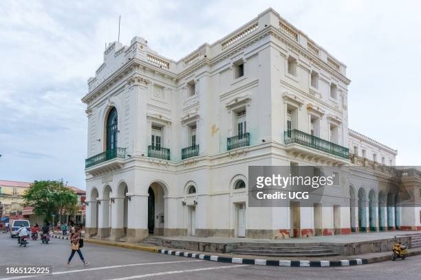 Santa Clara, Cuba, Cuban people out and about by the Charity Theater or Teatro La Caridad. The colonial building is a National Monument and tourist...