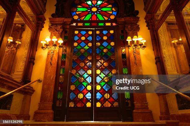 Murcia, Spain, The Royal Casino. Low angle view of the stained glass entrance door. The famous place is illuminated with symmetric lamps.