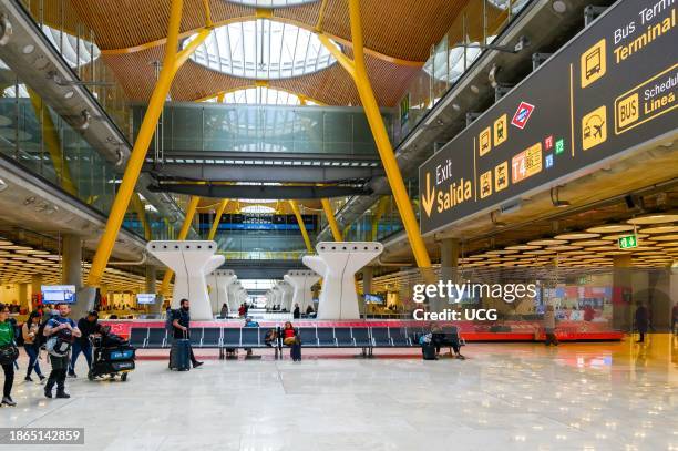 Madrid, Spain, People passengers walking in a large spacious hall in the transportation building. Modern architecture and design.