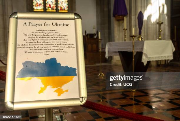 Noticeboard with a blue and yellow map of Ukraine offering a Prayer for Ukraine in the Catholic Arundel Cathedral of Our Lady & St Philip Howard in...