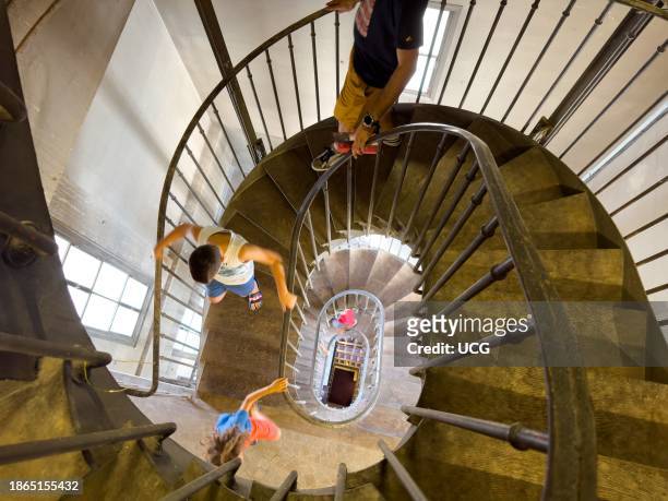 People walk down the spiral staircase within the clock tower within The Belfry of Montrouge, part of the local theatre, in Montrouge just outside...
