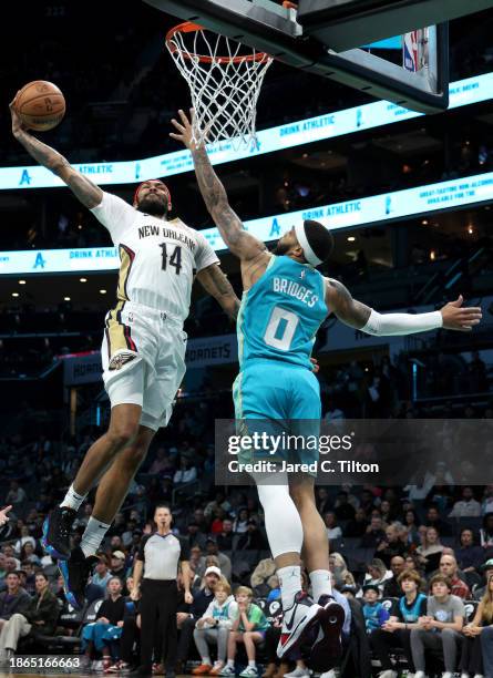 Brandon Ingram of the New Orleans Pelicans dunks the ball while being defended by Miles Bridges of the Charlotte Hornets during the first period of...