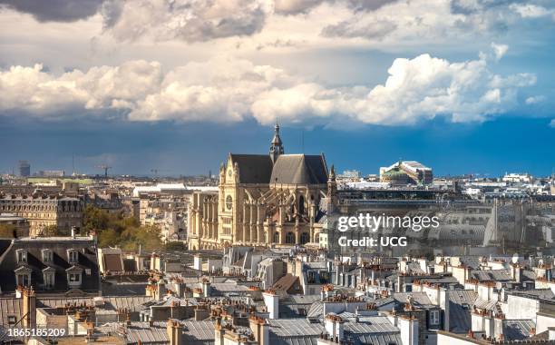 View over rooftops in Paris, France, looking west from the Pompidou Centre towards the Catholic Saint-Eustace Church and in the distance Saint Lazare...