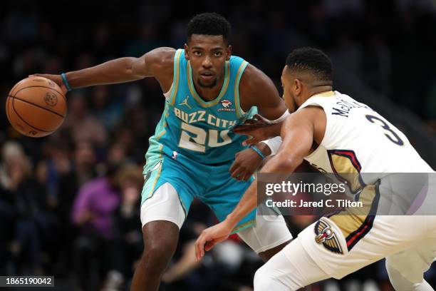 Brandon Miller of the Charlotte Hornets dribbles against CJ McCollum of the New Orleans Pelicans during the second half of the game at Spectrum...