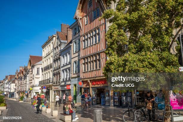 Shops and businesses housed in ancient medieval buildings in Rue Louis Ulbach, Troyes, Aube, France.