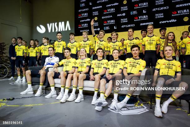 Group photo shows front row of cyclists: Christophe Laporte, Wout van Aert, Riejanne Markus, Sepp Kuss, Jonas Vingegaard, Olav Kooij and Fem van...