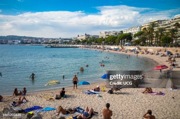 People relax on Zamenhof public beach in the late afternoon in Cannes in the south of France.