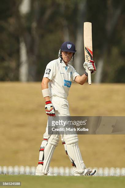 Scott Henry of the Blues celebrates his half century during day three of the Sheffield Shield match between the New South Wales Blues and the...