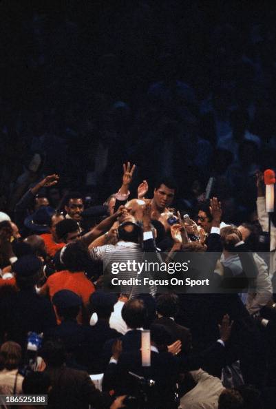 Ali Hand Rising Muhammad Ali with his hand raised is surrounded by the media after ...