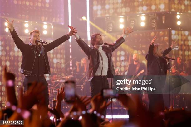 Take That perform onstage during the finale of The National Lottery's Big Bash to celebrate 2023 at OVO Arena Wembley on December 06, 2023 in London,...