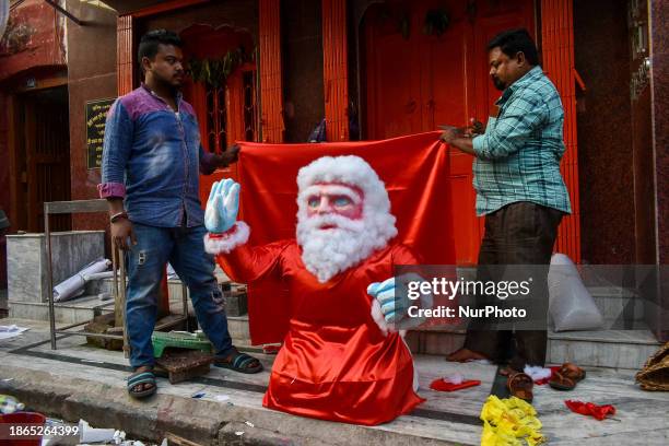 Artists are giving final touches to a styrofoam figure of Santa Claus ahead of Christmas in Kolkata, India, on December 21, 2023.