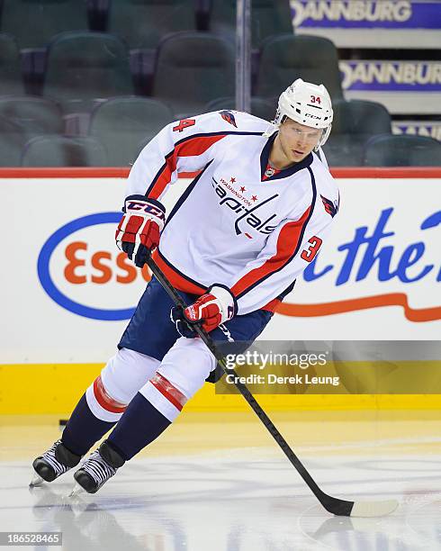 Alexander Urbom of the Washington Capitals skates against the Calgary Flames during an NHL game at Scotiabank Saddledome on October 26, 2013 in...