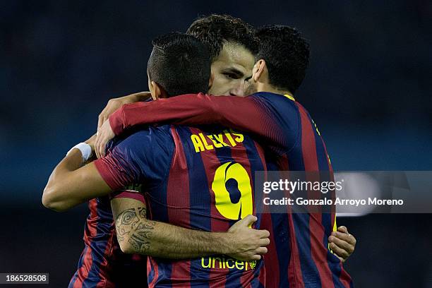 Cesc Fabregas of FC Barcelona embraces his teammate Alexis Alejandro Sanchez and Pedro Rodriguez Ledesma celebrating scoring their opening goal...