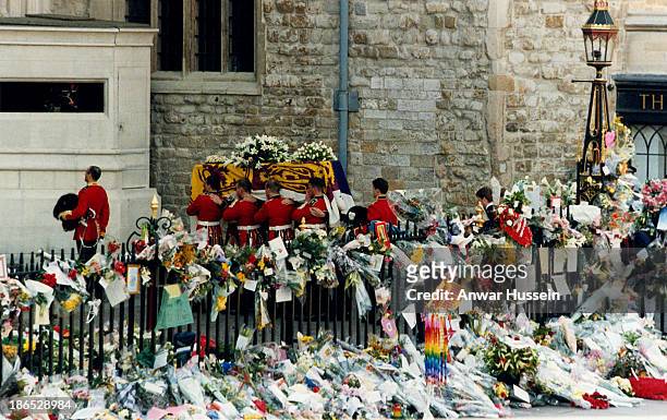 The coffin of Princess Diana, Princess of Wales, surrounded by floral tributes, is carried into Westminster Abbey for the funeral service on...