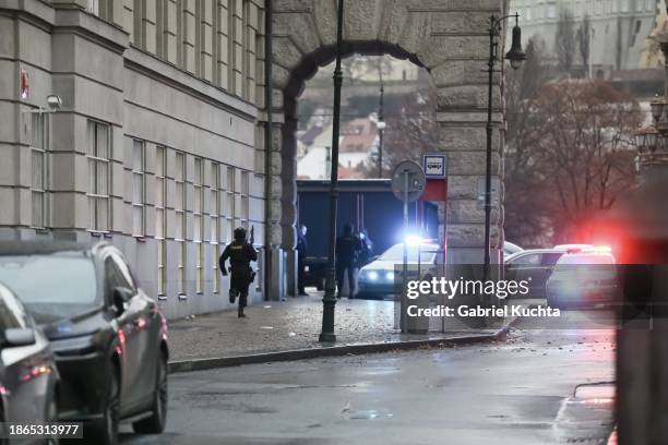 Police officer is seen running at the location of the shooting on December 21, 2023 in Prague, Czech Republic. A shooting leaves several dead and...