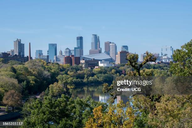 Minneapolis, Minnesota. Skyline showing the Mississippi river and US Bank Stadium in the fall.