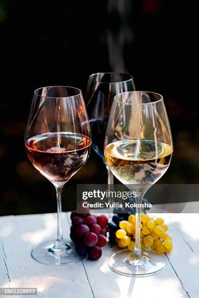 glasses of wine and grapes on a table in sunlight - wine glass from above stock pictures, royalty-free photos & images