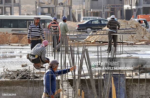 Foreign laborers work at a construction site in the Saudi capital Riyadh on October 30, 2013. Oil-rich Saudi Arabia, a magnet for mostly poor Asian...