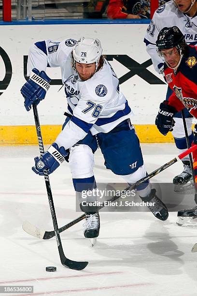 Pierre-Cedric Labrie of the Tampa Bay Lightning skates with the puck against the Florida Panthers at the BB&T Center on October 27, 2013 in Sunrise,...