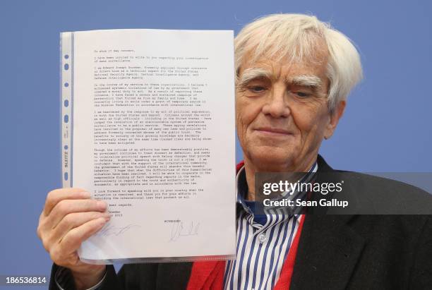 Hans-Christian Stroebele, member of the German Greens Party and the Bundestag, holds up a letter from Edward Snowden, former contractor with the...