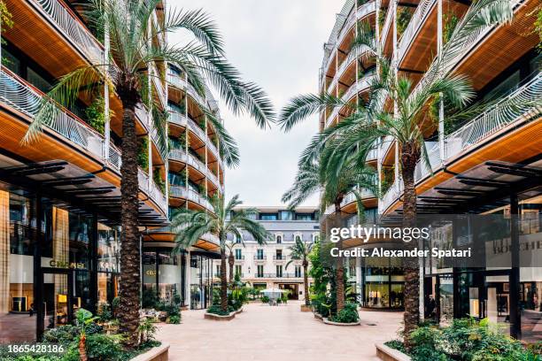 street with new apartment buildings and luxury fashion brand stores, monte carlo, monaco - monaco skyline stock pictures, royalty-free photos & images