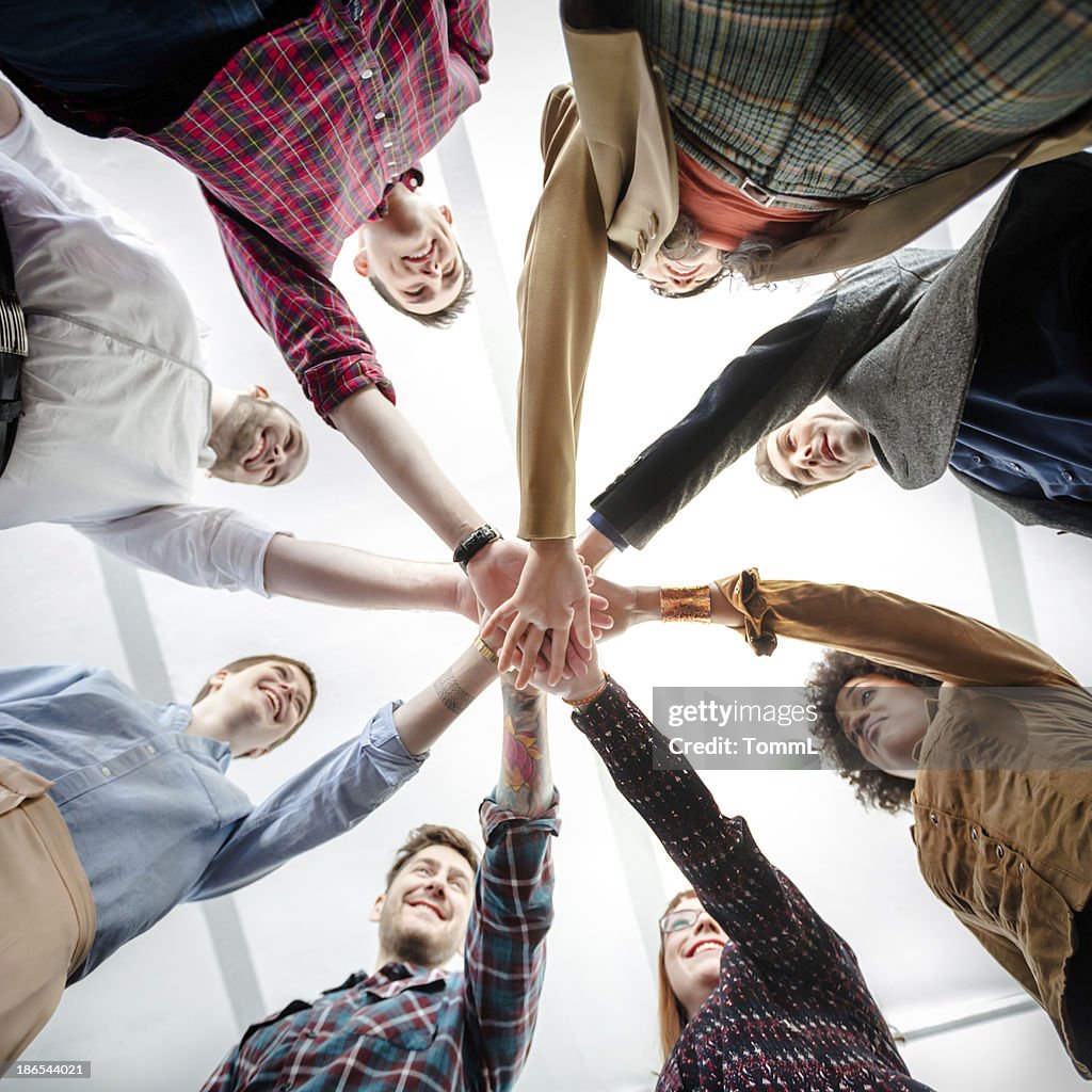 Young Business People Showing Team Spirit
