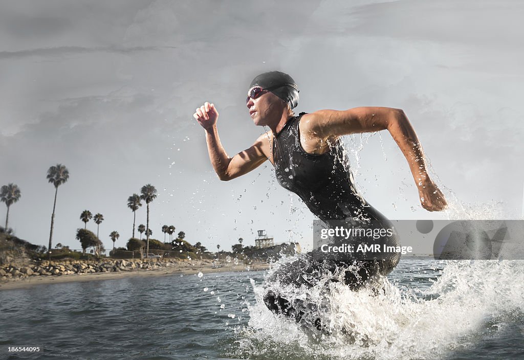 Female Triathlon Athlete rushing out of the water