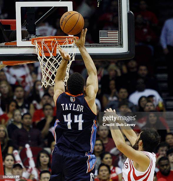 Jeffery Taylor of the Charlotte Bobcats puts back an offensive rebound past Omri Casspi of the Houston Rockets at Toyota Center on October 30, 2013...
