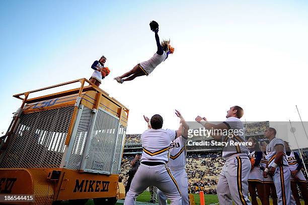 Cheerleaders of the LSU Tigers leap from Mike the Tiger's enclosure prior to a game against the Furman Paladins at Tiger Stadium on October 26, 2013...