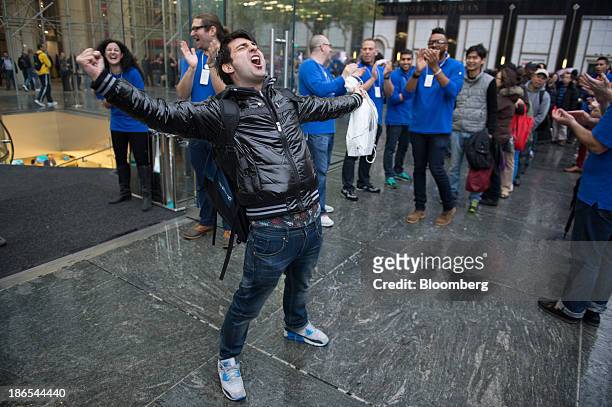 Rami Shamis celebrates after being the first to buy the new Apple Inc. IPad Air at the 5th Avenue Apple store in New York, U.S., on Friday, Nov. 1,...