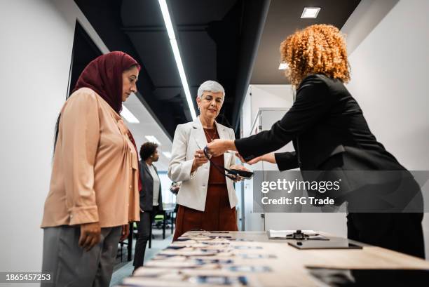 business conference participants registering for a conference - exhibition stock pictures, royalty-free photos & images