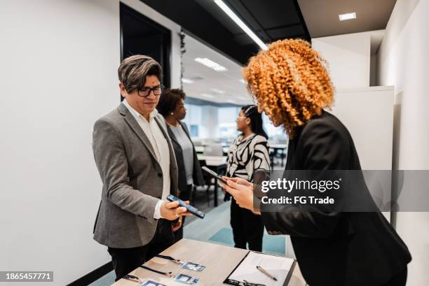 business conference participant registering for a conference - attending stock pictures, royalty-free photos & images