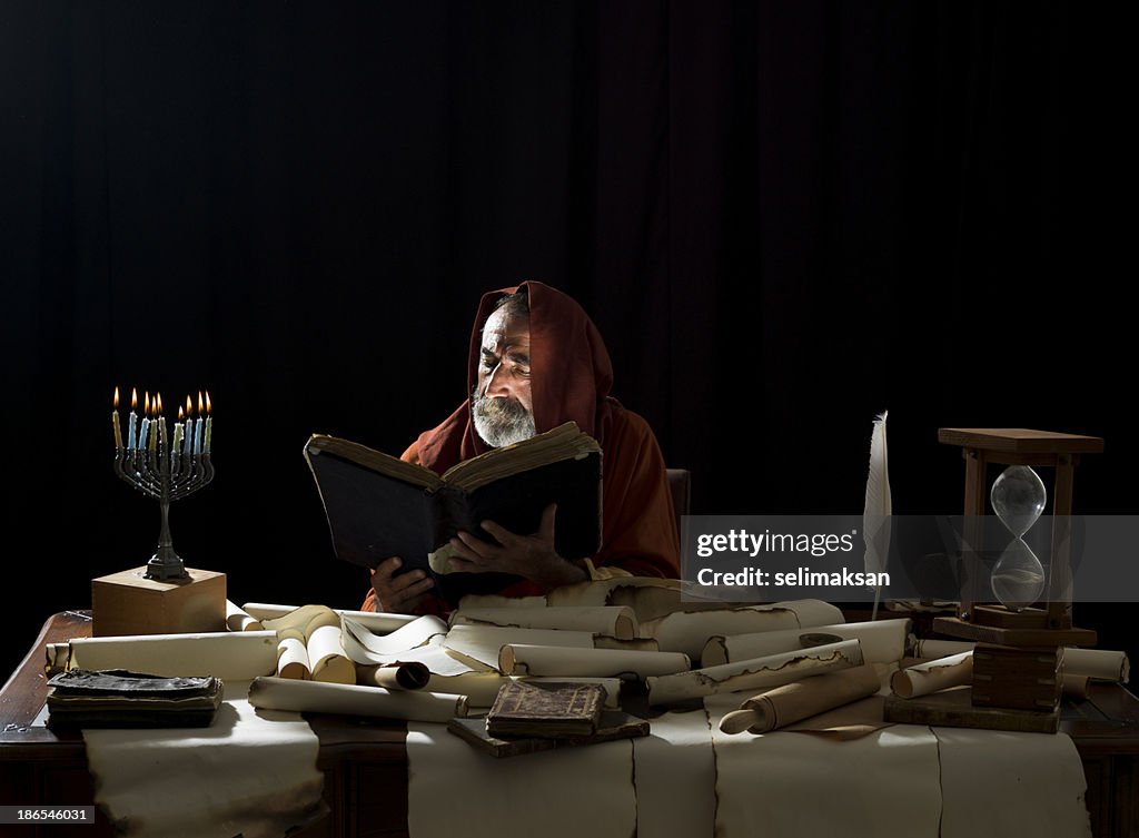 Medieval philosopher reading Torah in the light of menorah