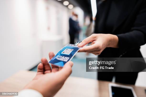 close-up of business participant getting badge on a conference - business conference stock pictures, royalty-free photos & images