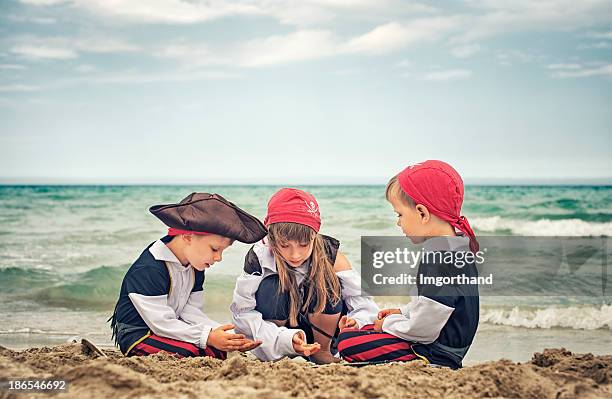 pirate kids and their treasure - burying money stock pictures, royalty-free photos & images