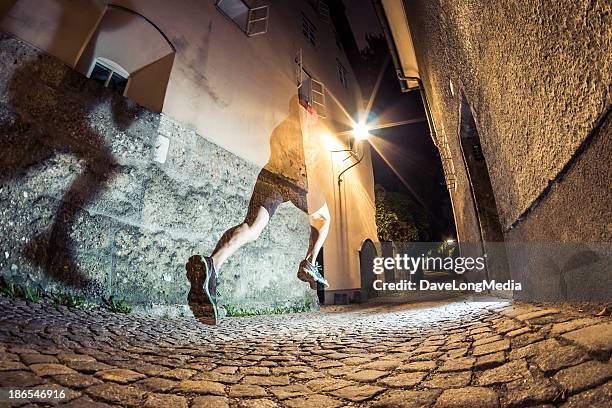 city running at night - ghost player stock pictures, royalty-free photos & images