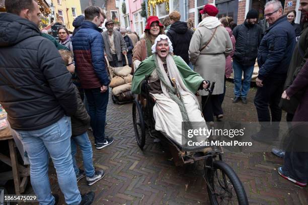 Three people dressed as characters from Charles Dickens' books participate in the Dickens Festival on December 16, 2023 in Deventer, Netherlands....