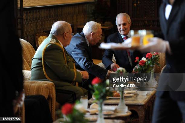 Algeria's Interior Minister Tayeb Belaiz speaks with Minister of War veterans Mohamed Cherif Abbas and chief of staff General Ahmed Gaid Salah at the...