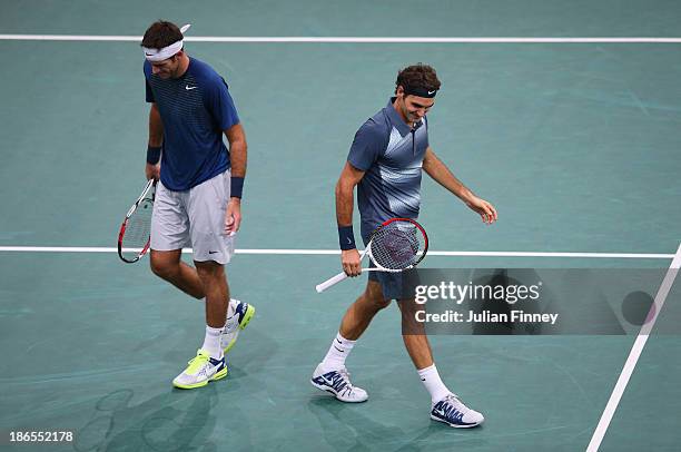 Juan Martin Del Potro of Argentina and Roger Federer of Switzerland enjoy a moment as they end up on the same side of the court during day five of...