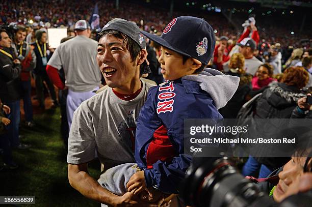 Koji Uehara of the Boston Red Sox celebrates with his son after defeating the St. Louis Cardinals in Game Six of the World Series on October 30, 2013...