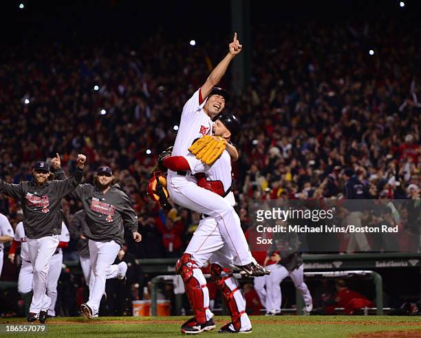 Koji Uehara and David Ross of the Boston Red Sox celebrate after defeating the St. Louis Cardinals 6-1 in Game Six and winning the World Series on...