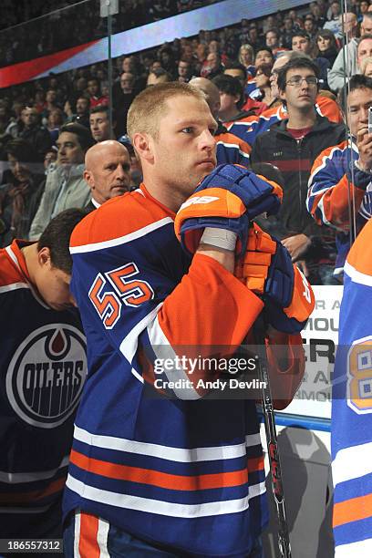 Ben Eager of the Edmonton Oilers stands for the singing of the national anthem prior to a game against the Washington Capitals on October 24, 2013 at...