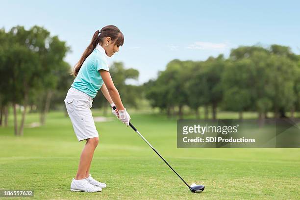 young golf player teeing off on course - play off stock pictures, royalty-free photos & images