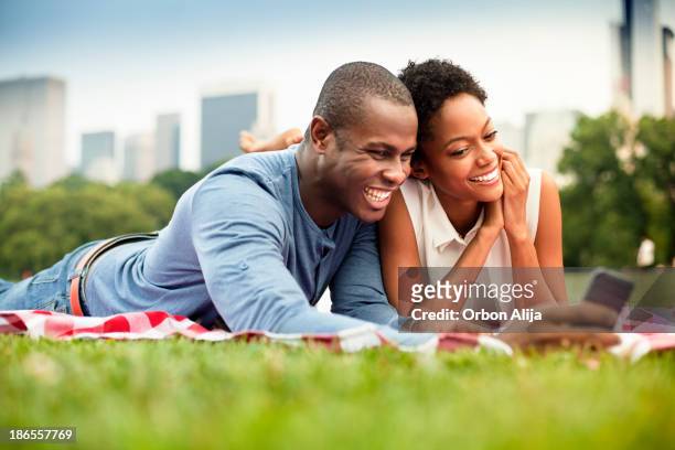 young couple in central park - couple central park stock pictures, royalty-free photos & images